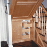 Storage space with drawers under a staircase
