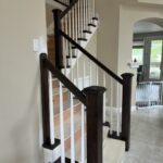 Wooden staircase with white railings.