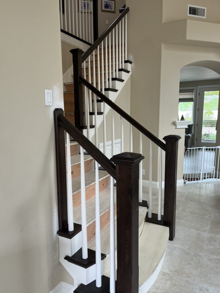 Wooden staircase with white railings.
